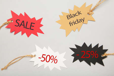 Sale tags with percent and incription sale on gray background. Black friday. Top viewの写真素材