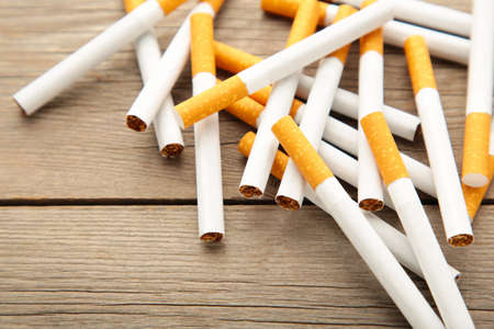 Cigarettes on a gray wooden background. Top view.の写真素材