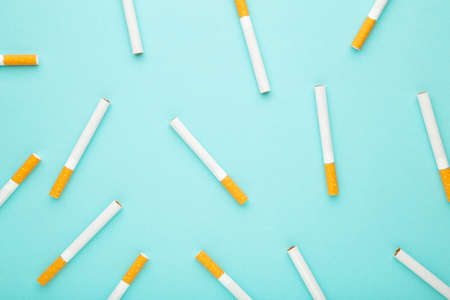 Many cigarettes on a blue background. Top view.の写真素材