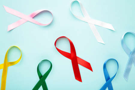 Collection of awareness ribbons on blue. World cancer day. Top viewの写真素材