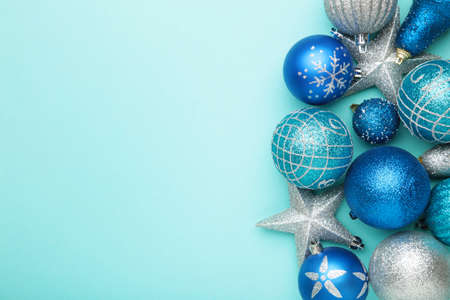 Silver and blue christmas decoration baubles on blue with space for text. Top viewの写真素材