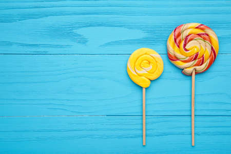 Colorful spiral lollipops on blue background. Top viewの写真素材