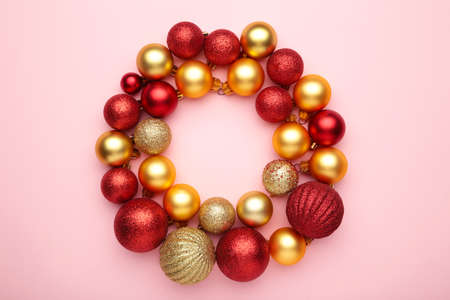 Red and gold christmas balls on pink background with copy space. Top viewの写真素材