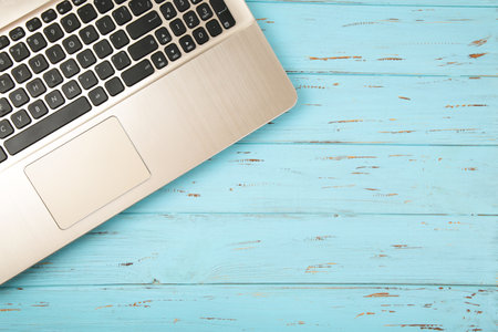 Laptop on blue background. Flat lay.の写真素材