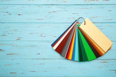 Colored cardboard palette, paper catalog on a blue wooden background. Top view.の写真素材