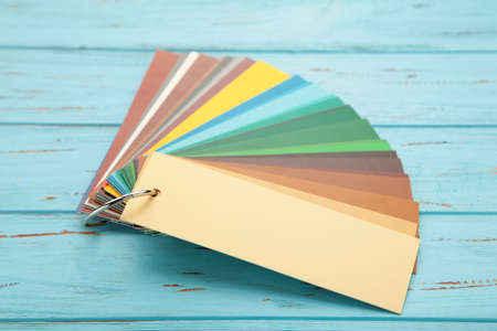 Colored cardboard palette, paper catalog on a blue wooden background. Top view.の写真素材
