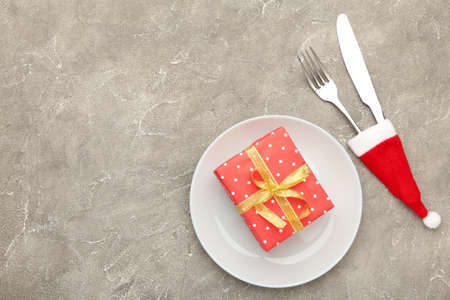Christmas dinner background with red gift on gray. View from above. Top viewの写真素材