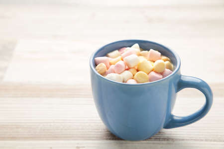 Cup of hot chocolate with marshmallow on gray wooden background.の写真素材