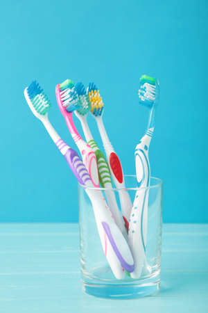 Toothbrushes in glass on blue background tools for oral care. Top viewの写真素材