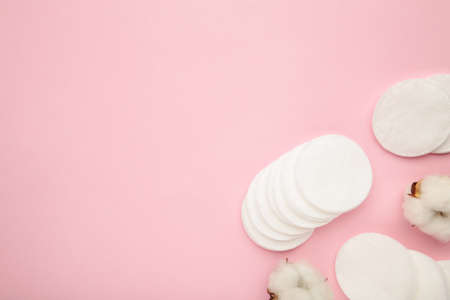 Hygienic disposable product cosmetic pads and cotton flower on pink background. Top viewの写真素材