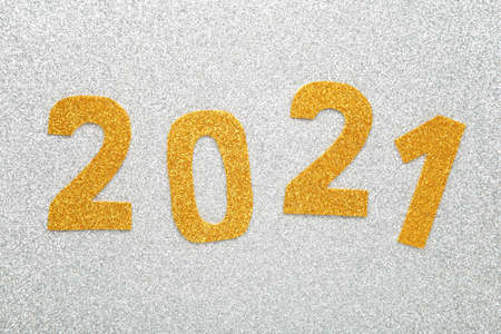 Happy New Year. Symbol from number 2021 on wooden background. Top view.