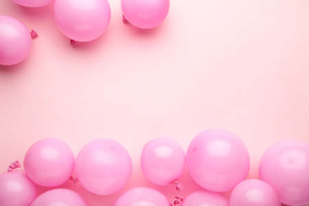 Pink balloons on pastel pink background. Birthday, holiday concept. Top view.
