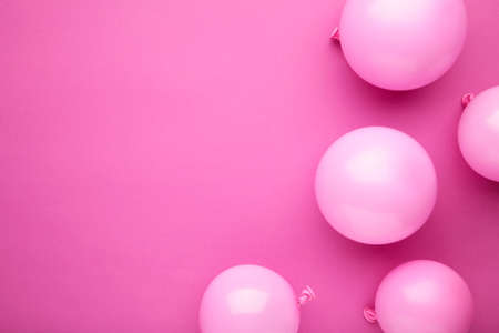 Pink balloons on pastel pink background. Birthday, holiday concept. Top view.の写真素材