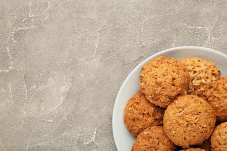 Stack of cookies on the plate on gray background. Top view