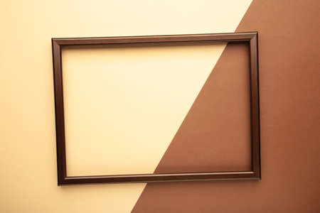 Brown frame on beige and brown background. Creative Flat lay Top view Mockup Copy space for text....