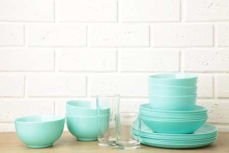 Stacks of mint ceramic dishware on light background. Top viewの写真素材
