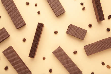Chocolate wafers with coffee on beige background. Top viewの写真素材