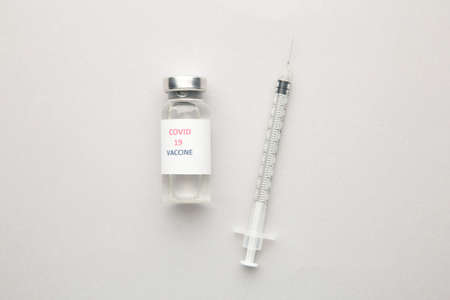 vaccine vials and syringe on gray background. Top viewの写真素材