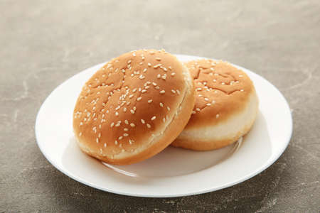 Hamburger buns in plate on gray background. Top viewの写真素材