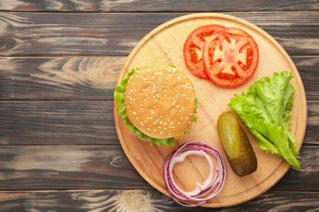 Homemade burger ingredients arranged on wooden background. Top viewの写真素材