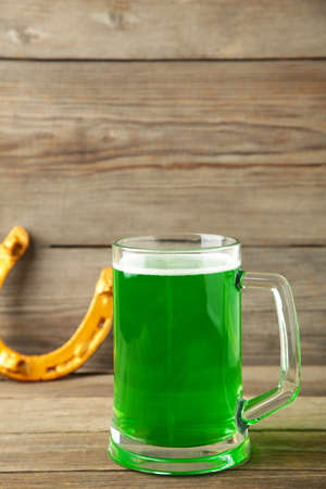 Glass of beer and horseshoe for St Patricks day on gray background. Top viewの写真素材