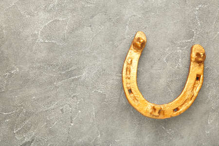 Gold horseshoe on gray background. St. Patricks day. Top viewの写真素材
