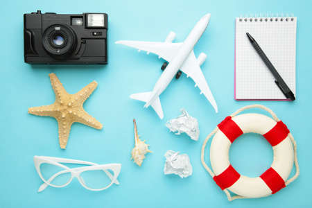 Planning summer holidays, tourism and trip vintage background. Travelers notebook with accessories on blue.の写真素材