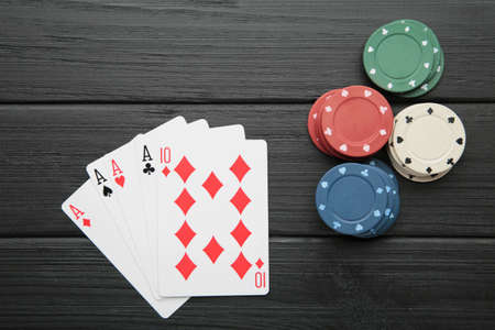 Poker chips on black wooden background. Casino. Top view