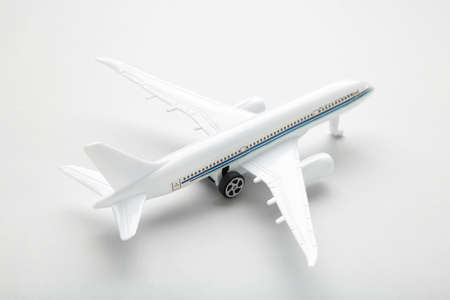 Model white airplane on a gray background. Travel concept