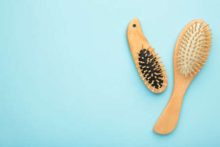 Set of comb and hairbrush on blue background. Top viewの写真素材