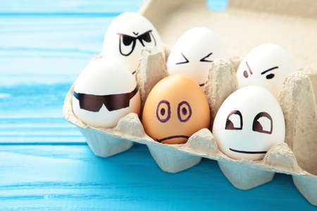 Eggs with different emotions on his face. Easter composition with copy space on blue background....