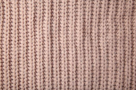 Beige knitted texture or background for text. Top view