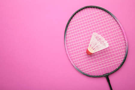 Shuttlecock and badminton racket on pink background. Top view.の写真素材