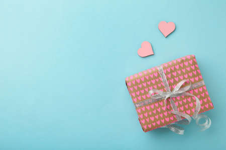 Present boxes with pink heart on blue background greeting card holidays concept. Top viewの写真素材