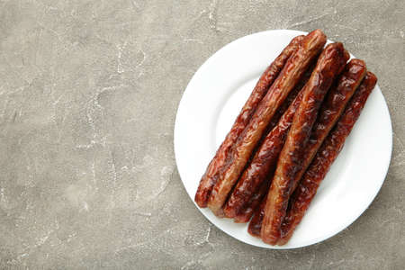 Roasted sausage on plate on gray background. Top viewの写真素材