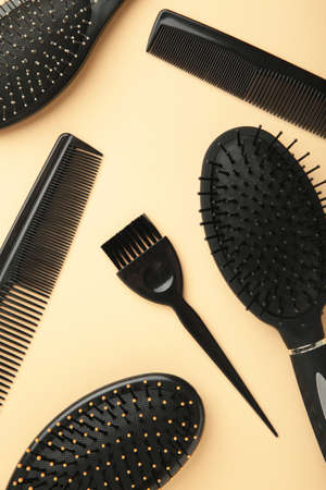 Hair tools, beauty and hairdressing concept - different brushes or combs on beige background. Top viewの写真素材