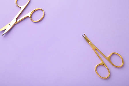 Scissors for manicure woman nails on purple background. Top viewの写真素材