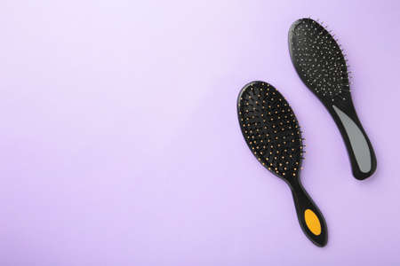 Set of different wooden hairbrushes on purple background. Top viewの写真素材