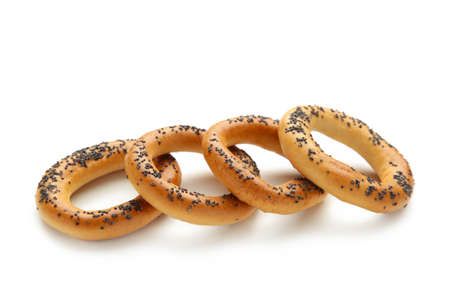Whole bagel with poppy seeds isolated on white background. Top view