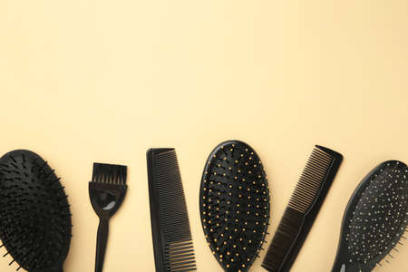Hair tools, beauty and hairdressing concept - different brushes or combs on beige background. Top viewの写真素材