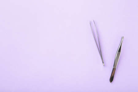 Beauty and fashion concept - tools for Eyelash Extension Procedure. Tweezers on pink background. Copyspace mockup. Top viewの写真素材
