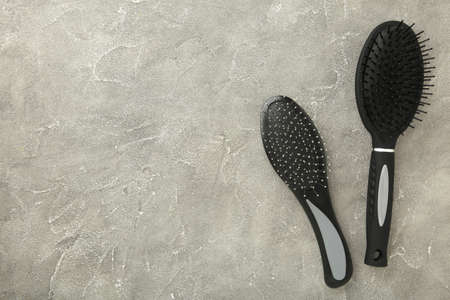 Set of different wooden hairbrushes on gray background. Top viewの写真素材