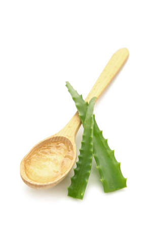 Aloe vera gel on wooden spoon with aloe vera isolated on white background. Top view.の写真素材