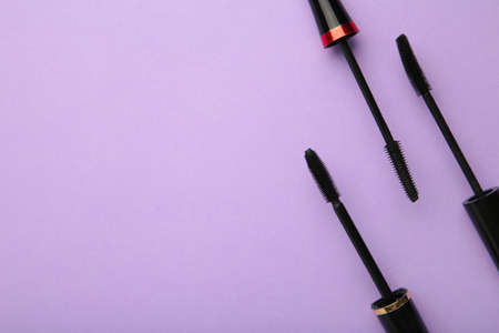 Various mascara wands on purple background with copy space. Top viewの写真素材