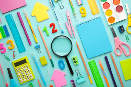 School supplies on blue background. Top view.
