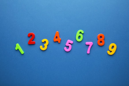 Magnetic multi-colored figures on a blue background. Back to school. Top view.の写真素材