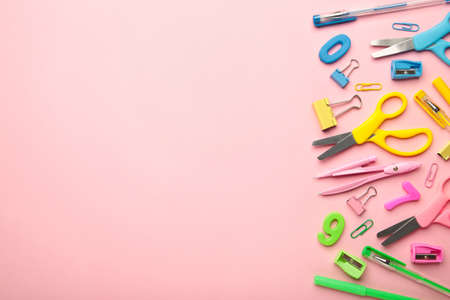 Blue, yellow, pink, green school supplies on pink background. Back to school concept. Top view.