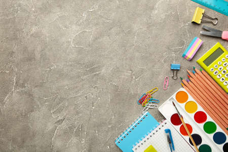 School supplies on gray concrete background with copy space. Back to school concept. Top view.の写真素材