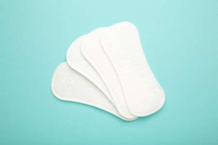 Sanitary pads on blue background. Women period. Top viewの写真素材