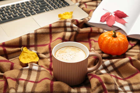 Hot coffee and autumn leaves with notebook on plaid - seasonal relax concept. Top viewの写真素材